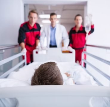 doctors-pushing-emergency-stretcher-bed-corridor_107420-63717